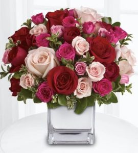 This lush rose arrangement of romantic pinks and reds will sing a song of love to your special someone's heart.