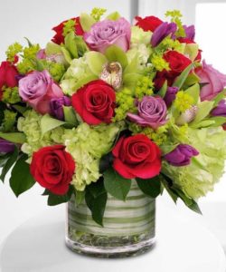 If extravagance and luxury is what you seek in a magnificent array of premium floral varieties, look no further than our exclusive Epicurean Delight bouquet. Boasting high end blooms, such as traditional Hydrangea, fragrant Roses, seasonal Tulips and contemporary Cymbidium Orchids, this stunning design bursts forth from its cylindrical clear glass vase, lined with real, decorative foliage.